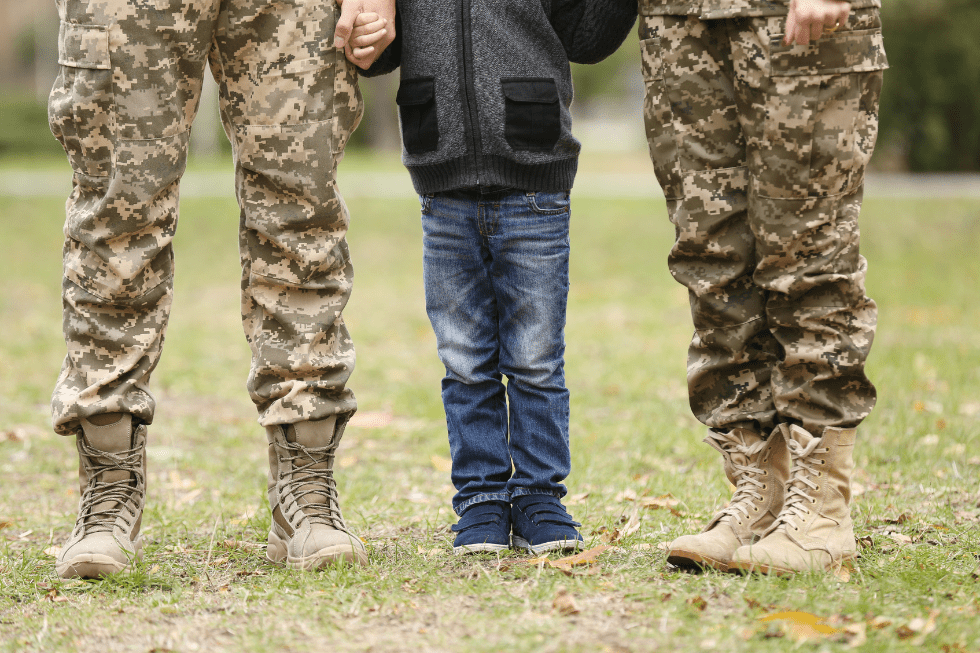 Military parents standing on either side of a child